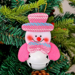 Pink snowman Christmas hanging ornament with metal bell base on pine needles