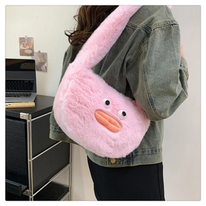 Detail of pink plush crossbody bag featuring a cute cartoon character design with fur texture