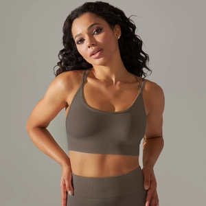 Detail of taupe ribbed seamless yoga set showing cross-back sports bra and high-waist leggings