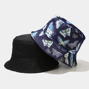 Reversible bucket hat with black and blue butterfly pattern for sun protection