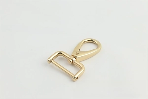 Close-up of golden swivel lobster clasp with rotating D-ring for bags and straps