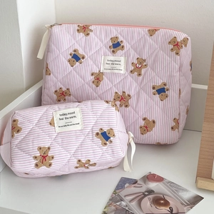 Detail of pink striped quilted bear makeup bags in large and small sizes with handle