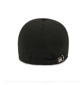 Detail view of black corduroy baseball cap back with adjustable metal buckle