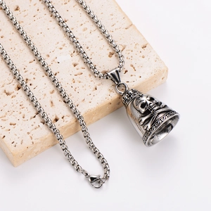 Polished stainless steel chain necklace with a skull relief bell pendant on stone