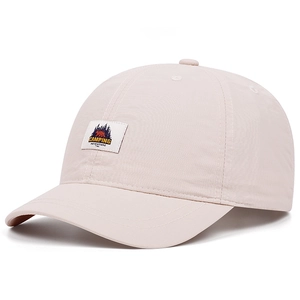 Detail of light pink quick-dry baseball cap featuring a Camping Adventure bear patch