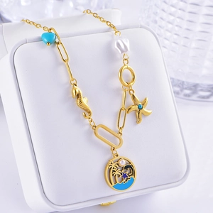 Close-up of gold seahorse and starfish pendants with blue enamel on jewelry box