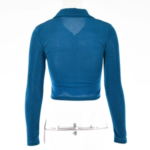 Rear view of a blue long-sleeved cropped cardigan with knit texture on mannequin