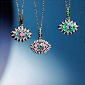 Three gold-plated evil eye pendant necklaces with colorful enamel and crystal accents