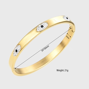 Detail view of 6mm wide gold evil eye bangle showing 59x50mm diameter and 21g weight