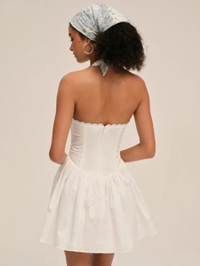 Detail of white backless mini dress with corset bodice and back zipper closure