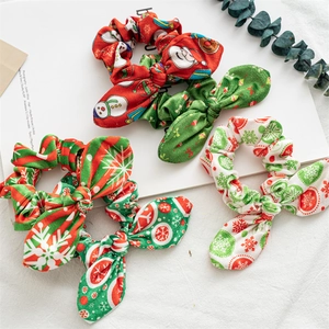 Detailed view of four Christmas theme scrunchies with bunny ears and holiday patterns