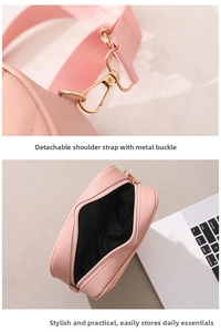 Detail of pink crossbody bag with detachable textile strap and gold metal hardware
