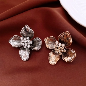 Detailed macro of vintage flower brooches in silver and rose gold with crystal centers