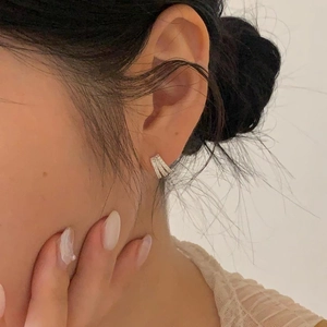 Close-up of model wearing double-row cubic zirconia hoop earrings in 925 silver