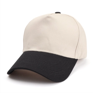 Detailed side view of two-tone trucker cap with cream crown and black brim contrast