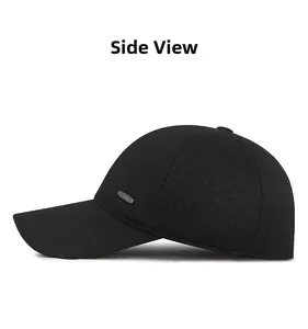 Side view of black winter cotton baseball cap with ear flaps and metal logo detail
