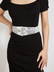 Close-up of silver snakeskin leather wide waist belt with interlocking metal ring buckle