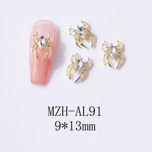 Detail showing 9x13mm gold spider nail charms with marquise diamond on pink nails