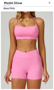Detail of rose pink sports bra and high-waisted shorts with side pocket for fitness