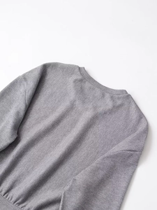 Detailed view of grey ribbed knit round neck texture and high-quality stitching detail