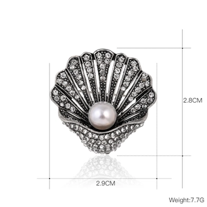 Vintage shell brooch with pearls and rhinestones on a retro silver-toned metal base