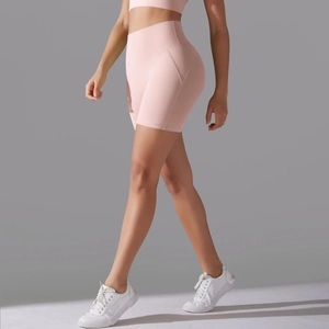 Detail of pink high-waisted yoga shorts with ergonomic side seams and compression fit