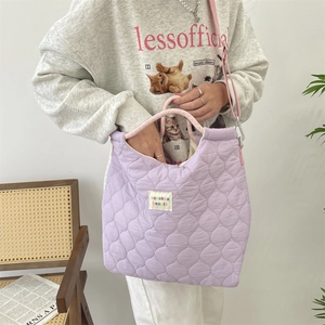 Détail du sac fourre-tout matelassé lavande avec poignées tressées et bandoulière