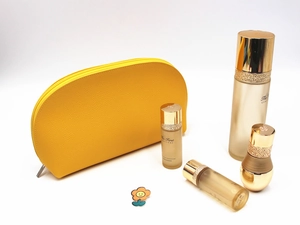 Detailed close-up of yellow pebble grain leather makeup bag with smooth metal zipper