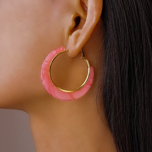 Close-up of pink marble pattern C-shaped acetate earring with gold metal inner lining
