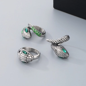 Detailed view of hip hop snake rings in vintage silver finish with green crystal eyes