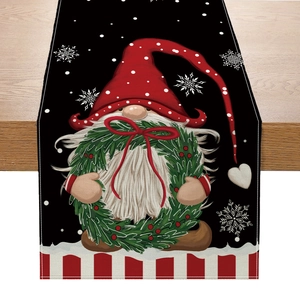 Linen Christmas table runner with Santa Claus, wreaths and snowflakes on wooden table