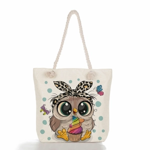 Detail of canvas tote bag showing cute cartoon owl print with thick rope handles