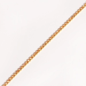 Close-up of a gold-plated tennis bracelet featuring claw-set amber cubic zirconia stones