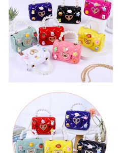 Detail of colorful mini jelly bags with pearl handles, cartoon patches and metal chains