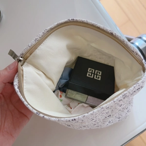Macro shot of a floral cotton makeup pouch interior showing zipper and storage capacity