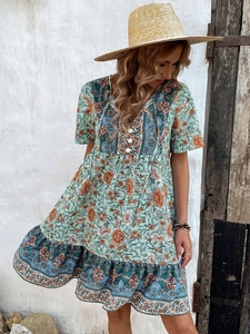 Full view of bohemian floral maxi dress in mint green with layered ruffle hem details