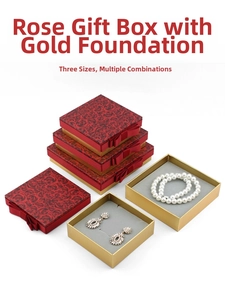 Macro detail of red rose patterned jewelry box with gold base and elegant bow