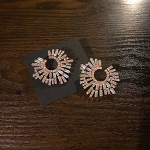 Radial gold earrings with iridescent AB crystals in a geometric C-shaped sunburst design