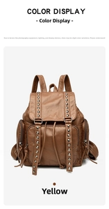 Detail view of large vintage backpack featuring rivet studs and washed leather texture