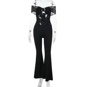 Detail of black lace off-shoulder jumpsuit featuring stud waist and flared leg style