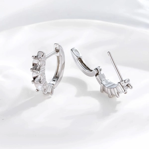 Silver 3mm cubic zirconia hoop earrings with hinged closure on a soft white background