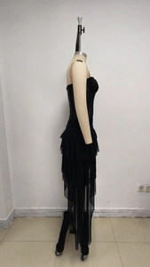 Detailed view of layered black tulle ruffles on a strapless dress with voluminous texture