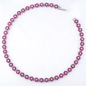 Detailed view of silver flower necklace with pink crystals and clear zircon accents