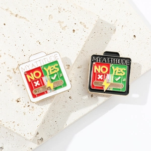Detail of sliding enamel pin showing MY ATTITUDE text on decorative stone surface
