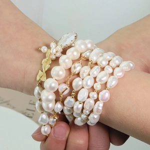 Handcrafted layered natural pearl bracelet with gold butterfly charms and baroque pearls
