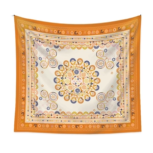 Detail showing the symmetrical orange mandala pattern on bohemian fabric wall tapestry