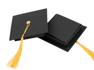 Detail of creative graduation cap gift box in black with a decorative yellow tassel