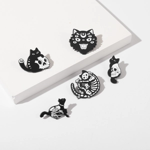 Set of five gothic black cat and skull enamel pins in minimalist monochrome style