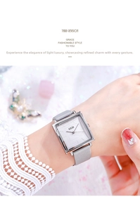 Close-up of a ladies' square silver quartz watch with a grey suede leather strap
