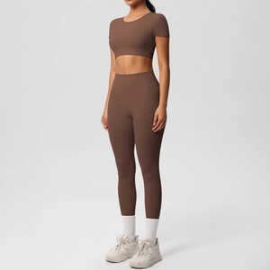 Détail d'un ensemble de yoga marron avec haut court à manches courtes et legging taille haute